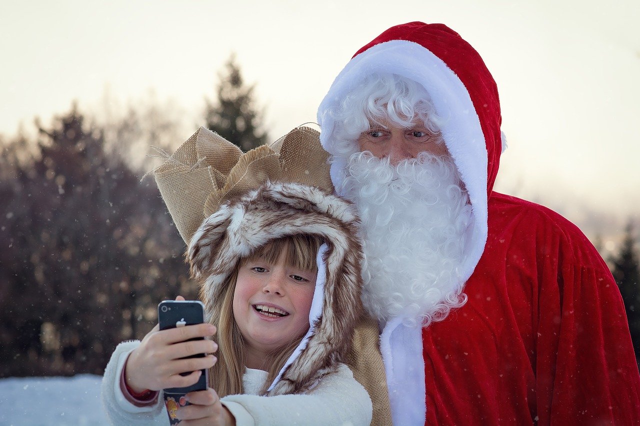 Santa standing with young boy for pictures